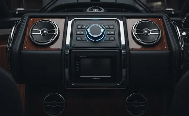 Premium audio control panel with speakers and central receiver mounted in a dashboard.